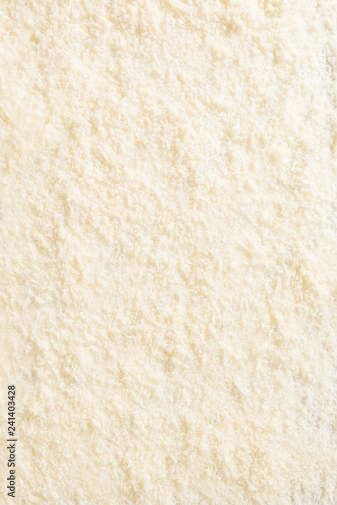 Grated parmesan cheese background from above. Grated parmesan cheese background from above.