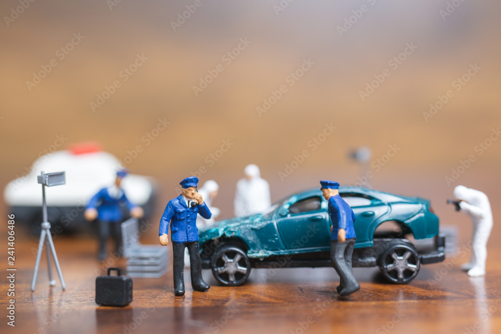 Miniature people : Police And Detective standing in front of car , Crime Scene Investigation concept Miniature people : Police And Detective standing in front of car , Crime Scene Investigation concept