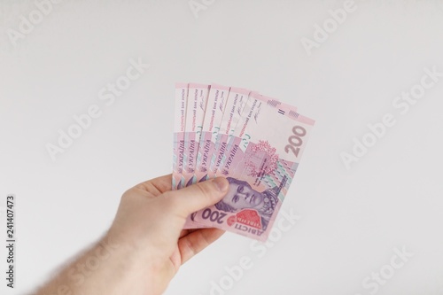 money of Ukrainian hryvnias in male hands.