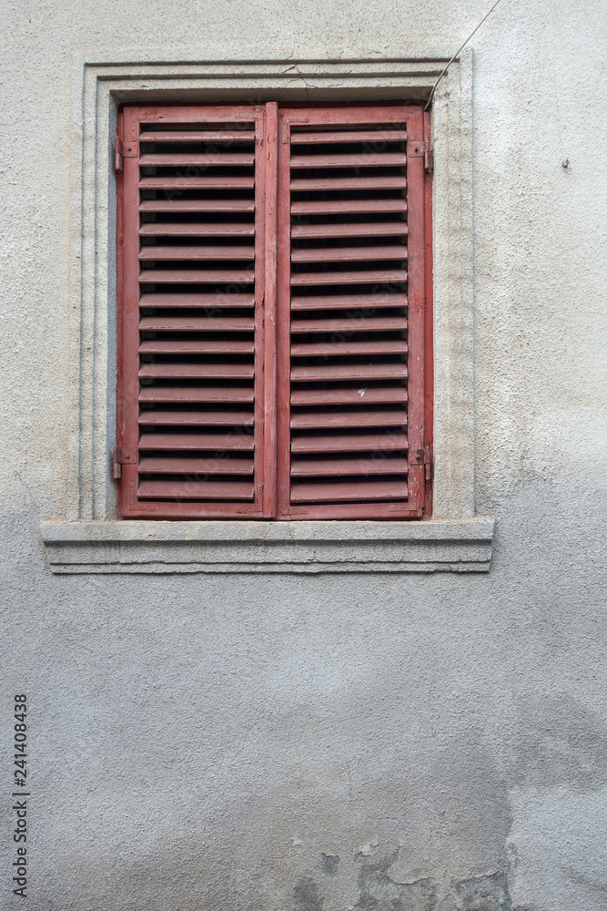 Fototapeta premium Window on the façade of a stone wall