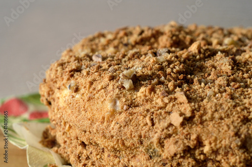 Sweet cake sprinkled with nuts close up