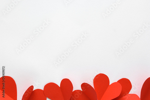 Valentines day card. Red paper hearts on white paper background. Paper cut style and minimalist concept
