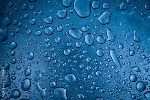 Water drops on metal surface. Macro with shallow depth of field.