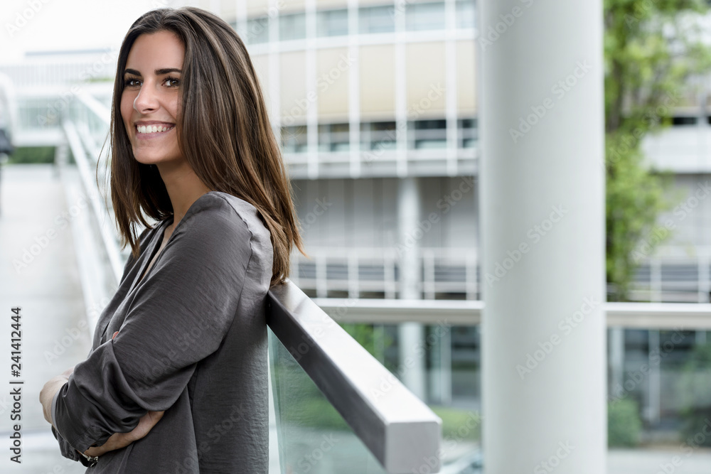 Smiling young businesswoman looking at distance