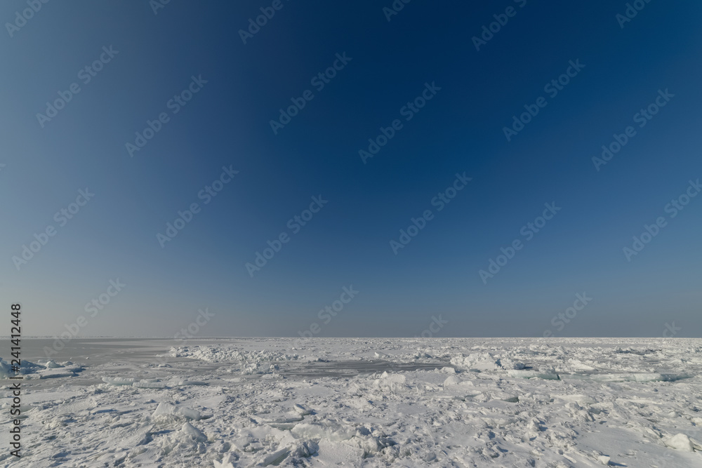 Frozen sea view on sunny day.