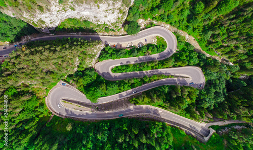 curved road with cars and beautiful forest landscape. Bicaz gorges, Romania. Aerial view from drone photo