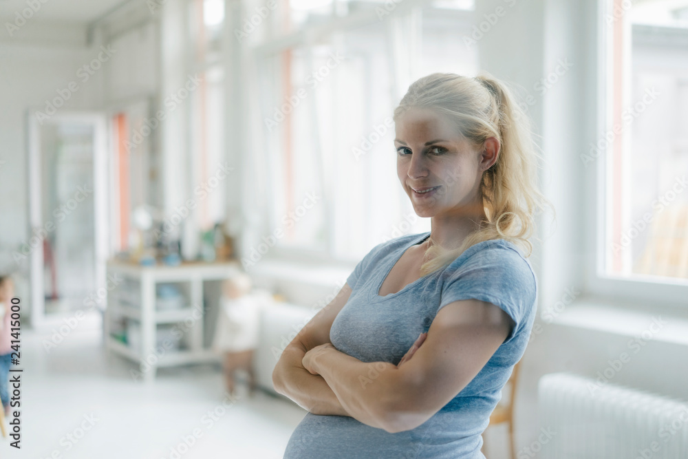 Portrait of smiling pregnant woman in a bright room Portrait of smiling pregnant woman in a bright room