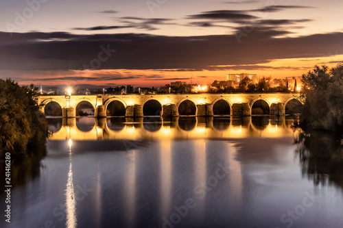 illuminated Roman bridge over Guadalquivir river at evening in Cordoba, Andalusia, Spain