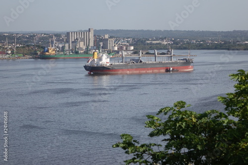 Photography A freight ship guided into port by a harbor tug in Havana Cuba