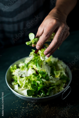 Bild auf Leinwand man preparing a salad
