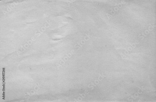 A sheet of plain white paper with a crumpled surface
