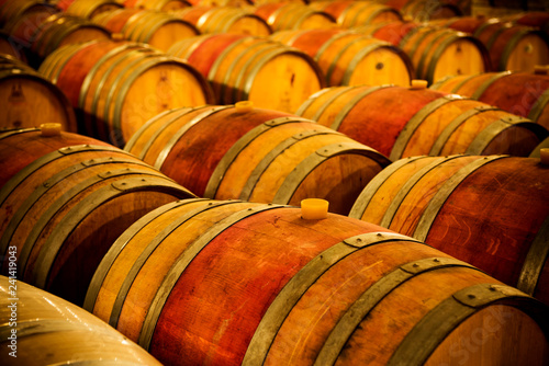 Wine barrels stacked in the cellar of the winery. photo