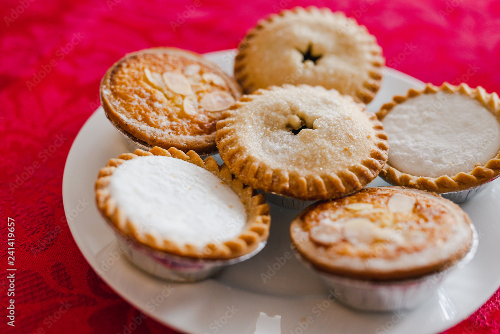 mince pies on Christmas table setting with with red cloth