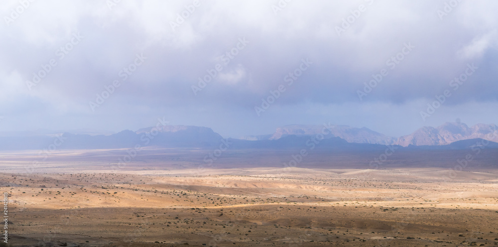 Low  dense fog falls on a stone desert in the south of Jordan