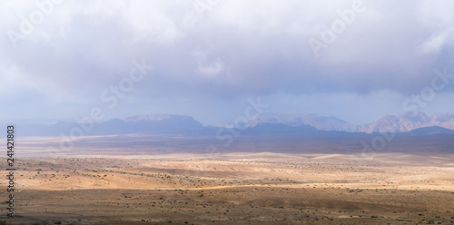 Low dense fog falls on a stone desert in the south of Jordan