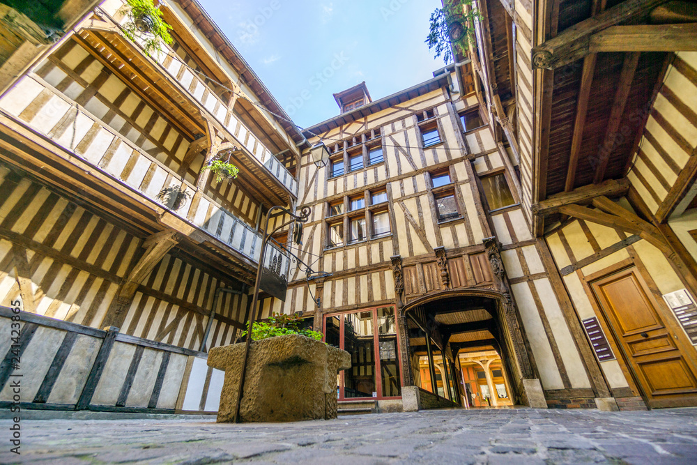 Medieval courtyard surrounded by half timbered houses with well in the middle of it, Troyes, France