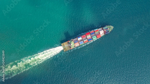 Container ship in export and import business logistics and transportation. Cargo and container box shipping to harbor by crane. Water transport International. Aerial view and top view.