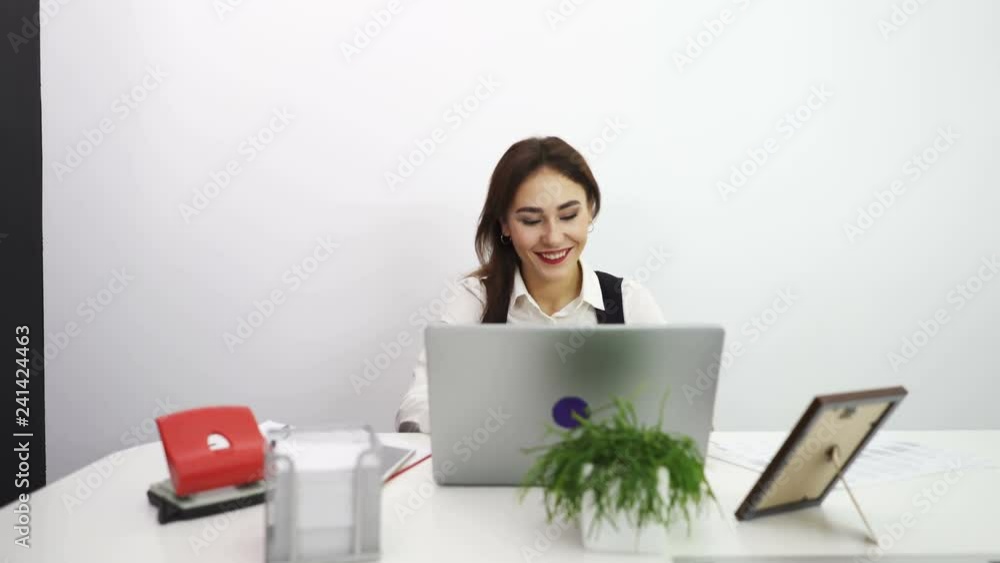 4К. Asian smiling business woman work at notebook in office. Dolly shot 4К. Asian smiling business woman work at notebook in office. Dolly shot