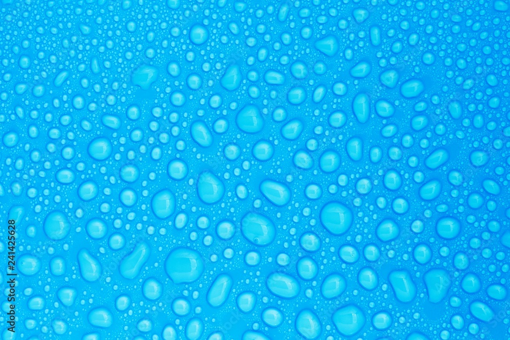 closeup drops water on blue background closeup drops water on blue background