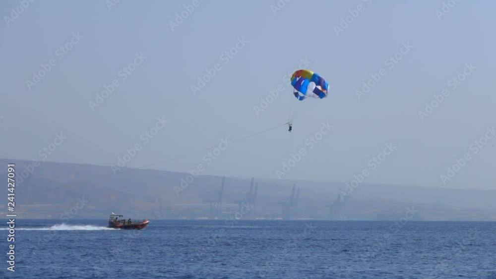 Motor boat tows a special parachute over the sea, sea resort, entertainment Motor boat tows a special parachute over the sea, sea resort, entertainment