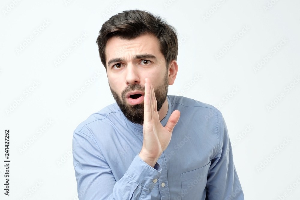 Man whispering gossip isolated on a white background Man whispering gossip isolated on a white background