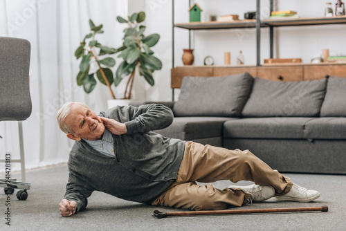 old men falled down on floor and touching neck © LIGHTFIELD STUDIOS