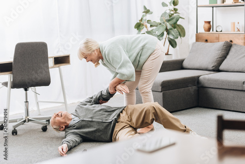 old woman helping to husband who falled down on floor