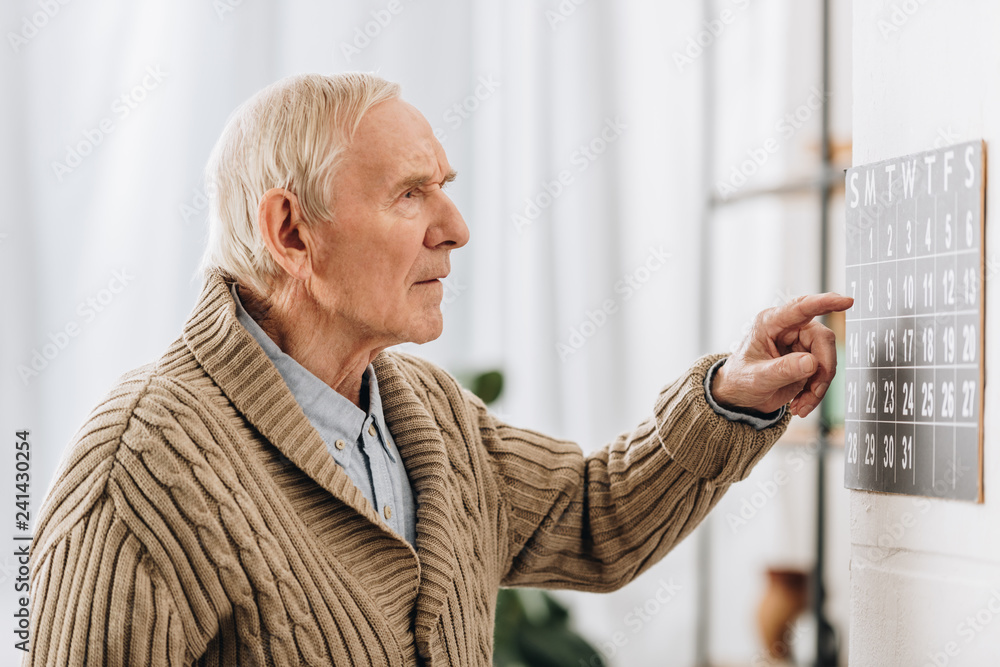 old man looking at calendar and remembering dates Stock Photo | Adobe Stock