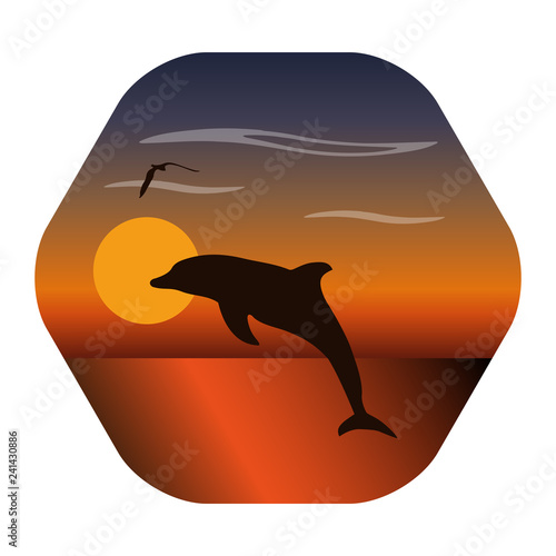 Landscape image of a sunset with jumping dolphin and a seagull silhouette. The dawn sun in the background and clouds above. Seascape with reflection in water. Concept of peace, travel and holiday.