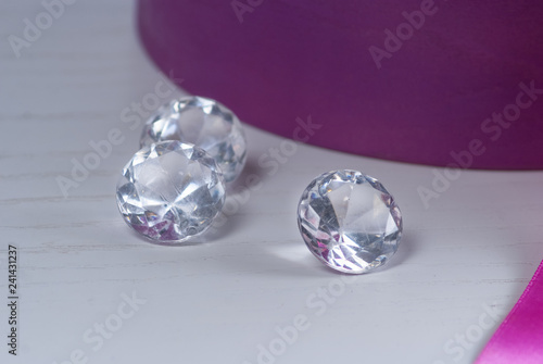 decorative diamonds on the table near violet box with flowers