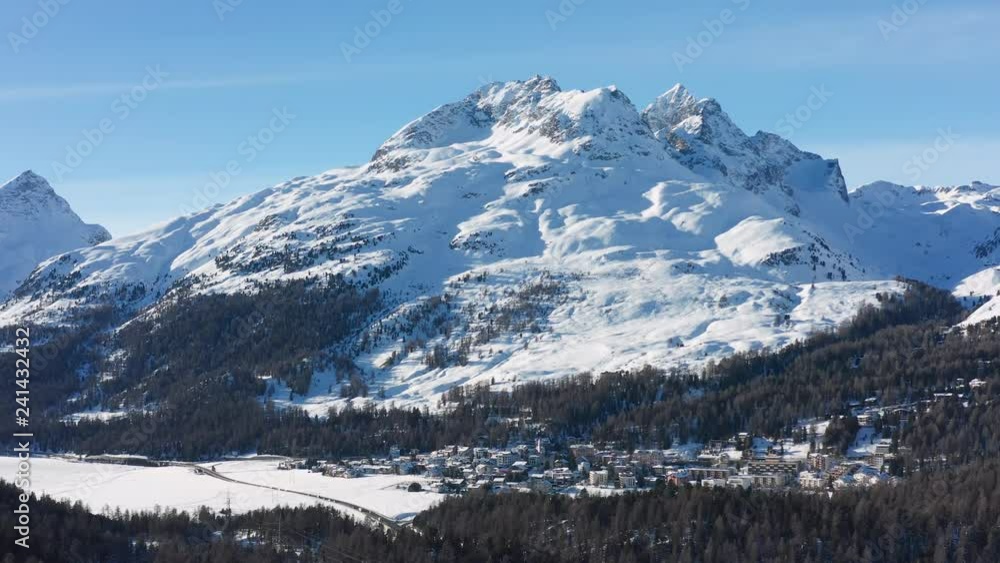 Aerial view of Champfer village in Swiss Alps mountains during winter, sunny day with blue sky - St. Moritz, landscape panorama of Switzerland, Europe Aerial view of Champfer village in Swiss Alps mountains during winter, sunny day with blue sky - St. Moritz, landscape panorama of Switzerland, Europe