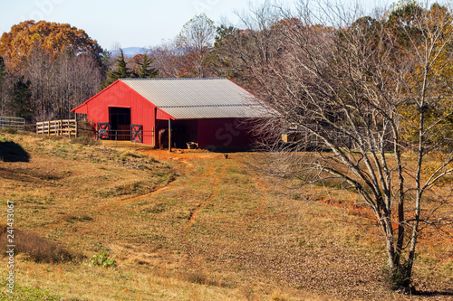 Red barn in Cherokee County Georgia at the end of fall.