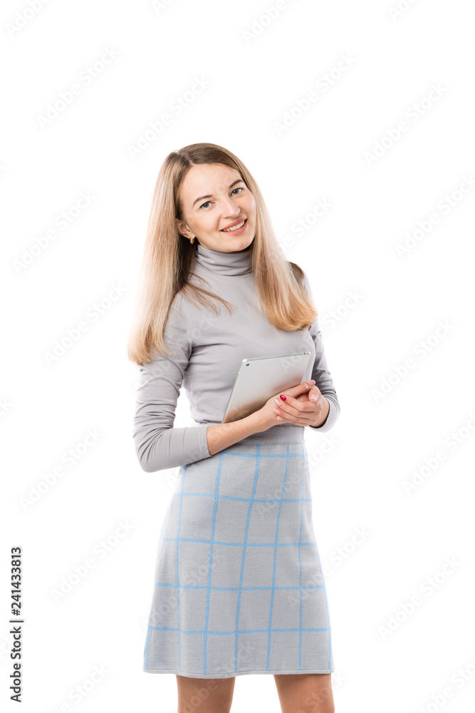 Theme business woman technology. Beautiful young caucasian blond woman in gray dress posing standing with tablet hands on white isolate background. Profession Marketer Sales Social Media Advertising Theme business woman technology. Beautiful young caucasian blond woman in gray dress posing standing with tablet hands on white isolate background. Profession Marketer Sales Social Media Advertising