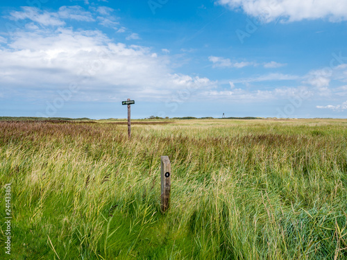 Salt marshes with no entry warning sign and beacon in nature reserve Het Oerd on West Frisian island Ameland, Friesland, Netherlands