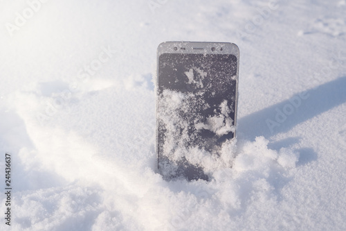 Fototapeta Naklejka Na Ścianę i Meble -  phone in snow
