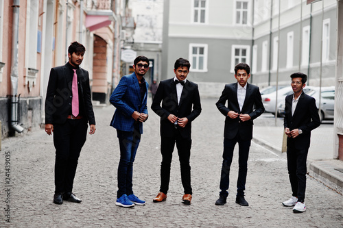 Group of 5 indian students in suits posed outdoor.