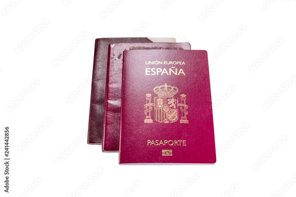 New spanish passport over old expired ones and white background New spanish passport over old expired ones and white background