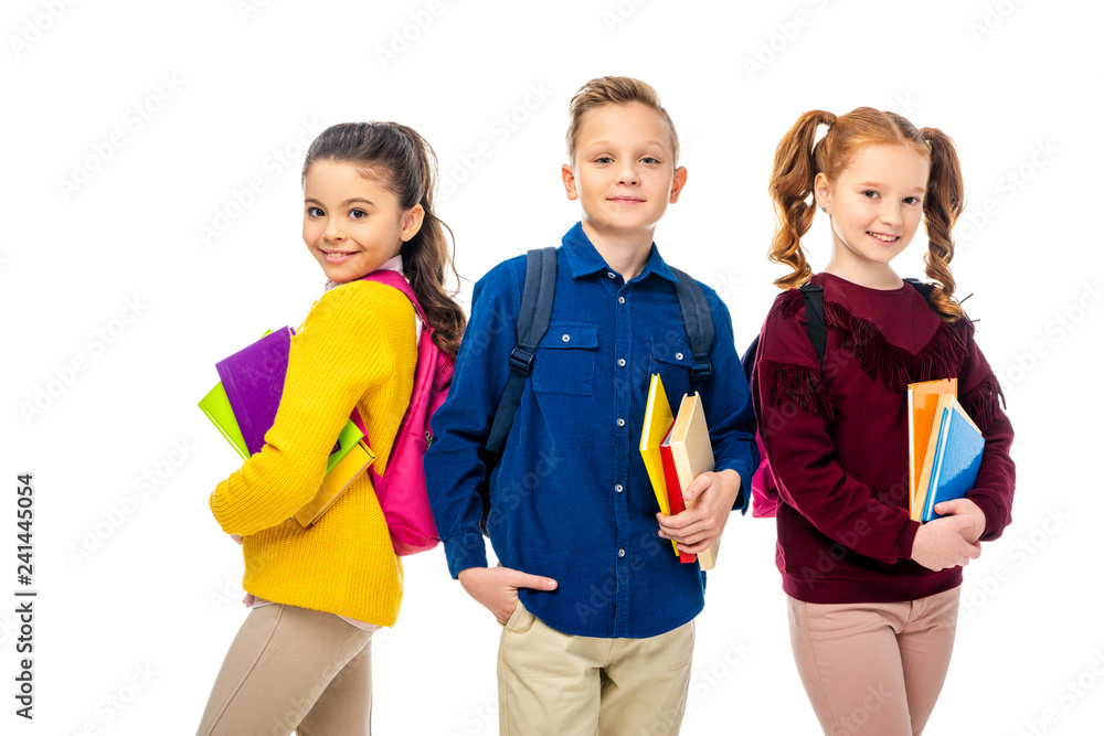 schoolchildren with backpacks holding books isolated on white schoolchildren with backpacks holding books isolated on white