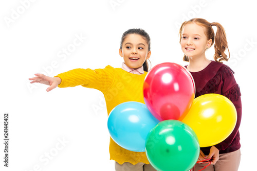 cheerful schoolgirls holding colorful balloons isolated on white