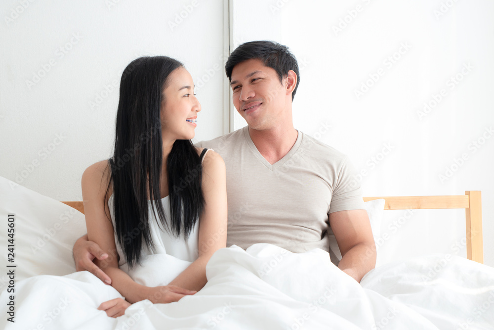 Young lovely couple on the bed together with smiling and happiness. boyfriend,girlfriend, love and valentine concept Young lovely couple on the bed together with smiling and happiness. boyfriend,girlfriend, love and valentine concept