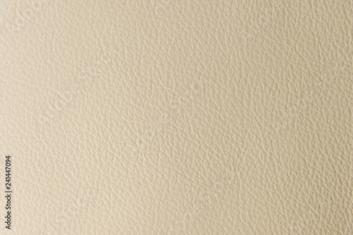 Textured background surface of textile upholstery furniture close-up. leatherette beige color fabric structure