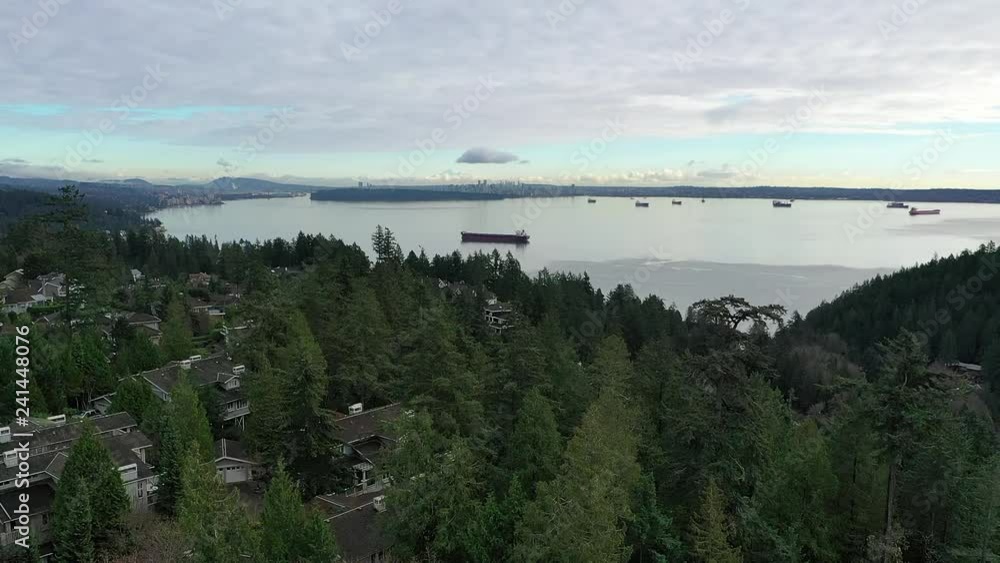Aerial view over Burrard Inlet, ocean and island with boat and mountains in beautiful British Columbia. Canada. Aerial view over Burrard Inlet, ocean and island with boat and mountains in beautiful British Columbia. Canada.