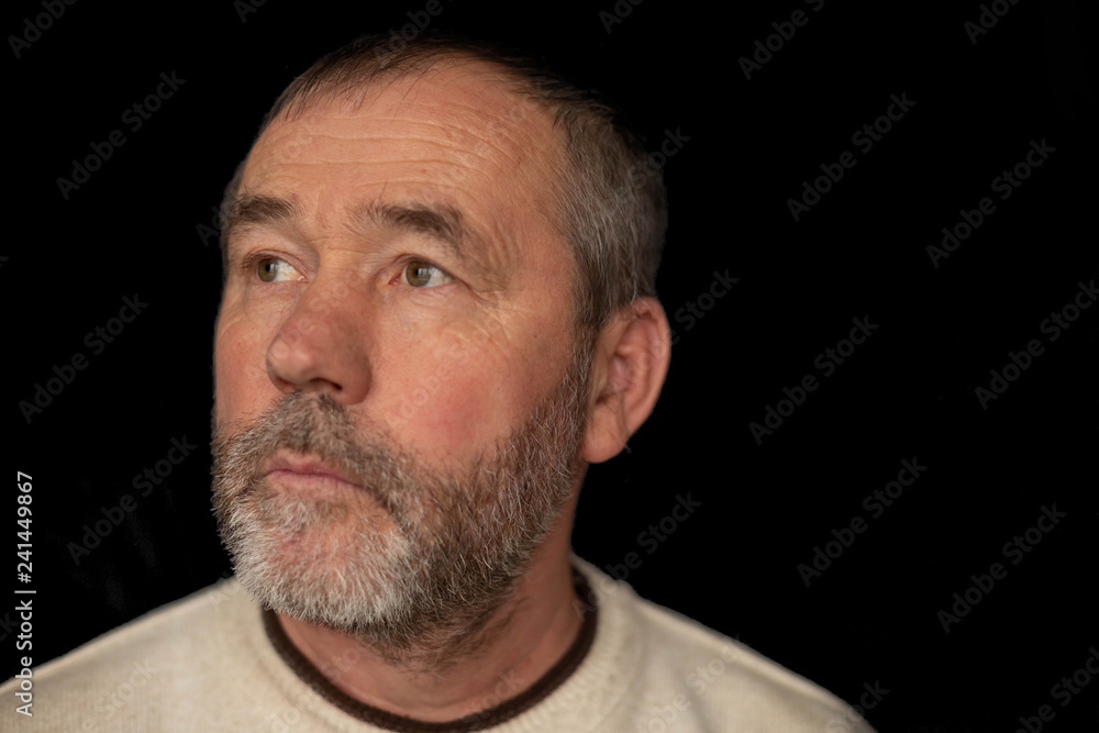 portrait of a gray-bearded man on a black background portrait of a gray-bearded man on a black background