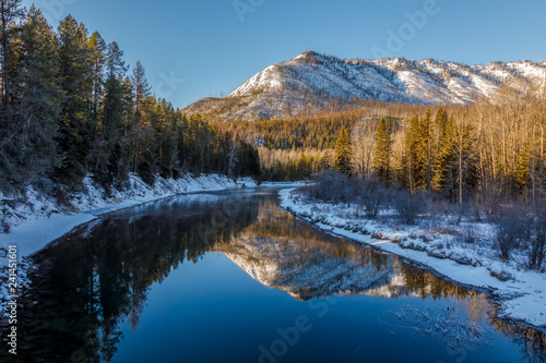 Peaceful calm sunny day at McDonald Creek, Glacier National Park, Montana in December