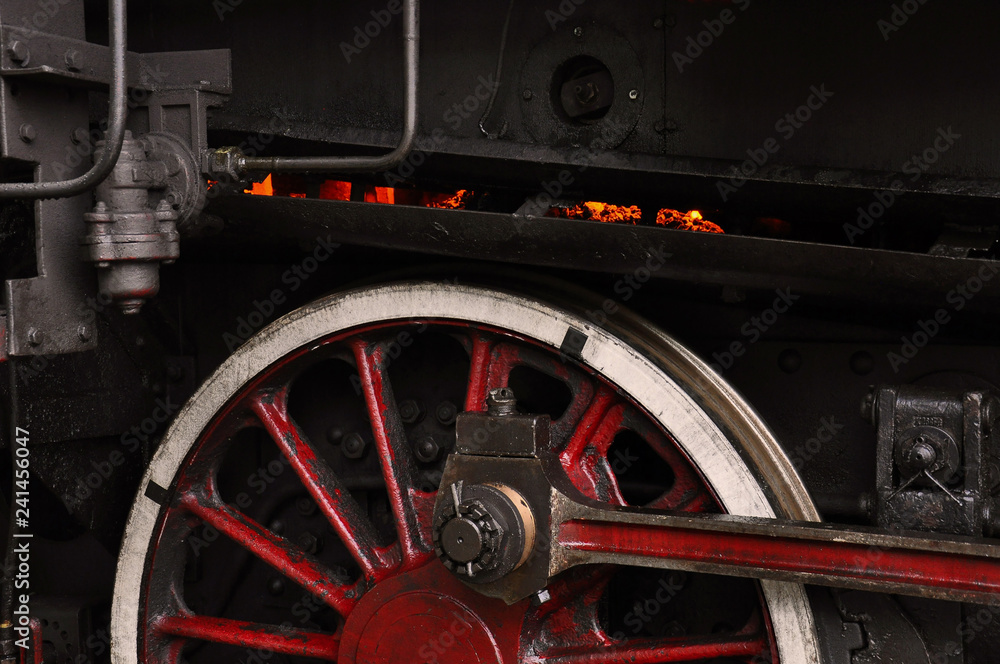 Fototapeta premium Red-hot coal in furnace and red wheel of a steam locomotive