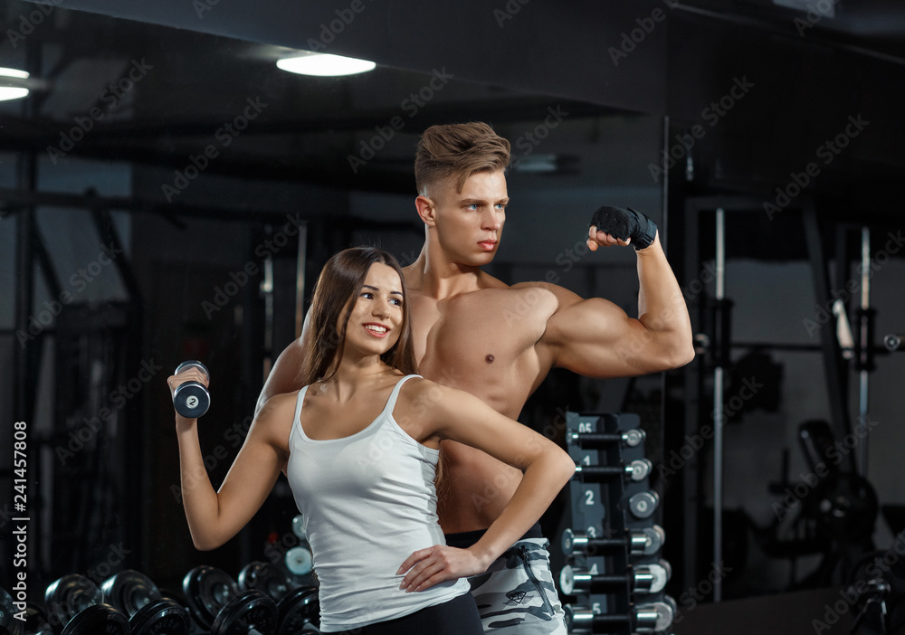 sport, training, fitness, lifestyle and people concept - young woman with personal trainer flexing back and abdominal muscles on bench in gym sport, training, fitness, lifestyle and people concept - young woman with personal trainer flexing back and abdominal muscles on bench in gym