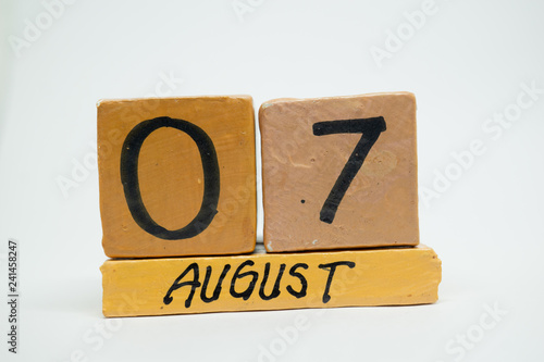 august 7th. Day 7 of month, handmade wood calendar isolated on white background. summer month, day of the year concept