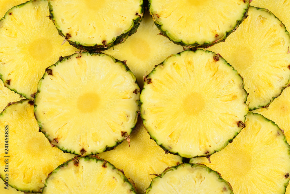 Pineapple juicy yellow slices background. Top view. Pineapple juicy yellow slices background. Top view.