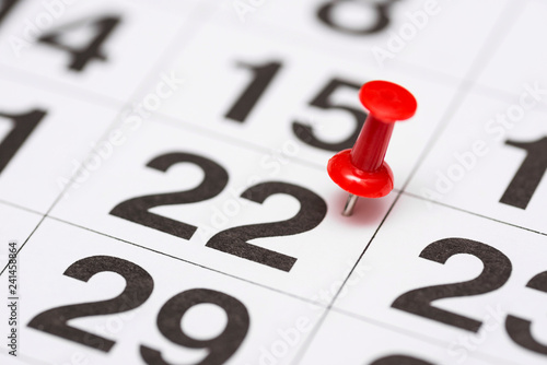 Pin on the date number 22. The twenty second day of the month is marked with a red thumbtack. Pin on calendar photo