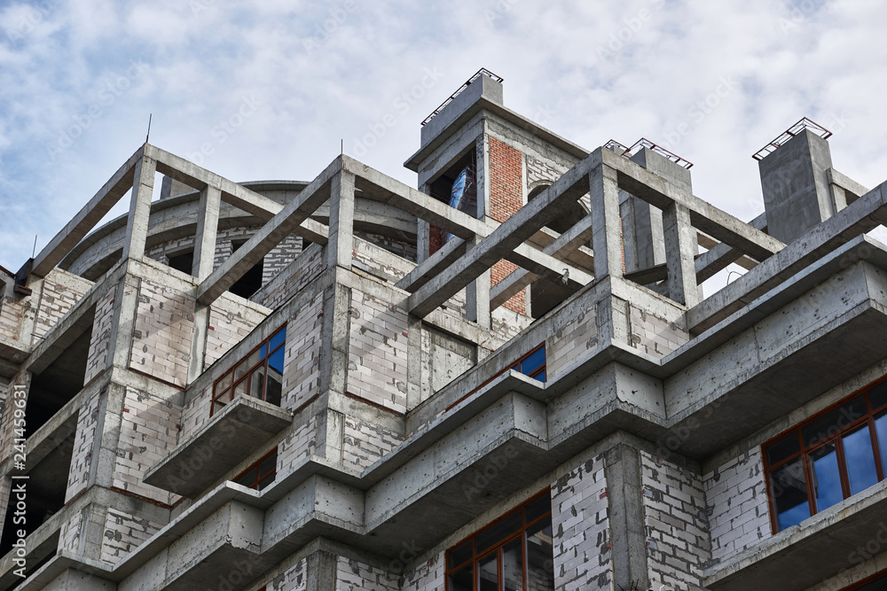 Fototapeta premium new building under construction, scaffolding and concrete